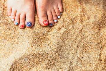 female sea style pedicured feet on summer shore sand on sunny da - 80431253