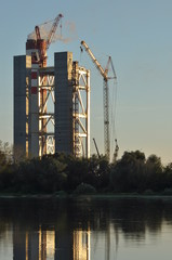 Power plant. Crane at a construction site. Chimney and smoke