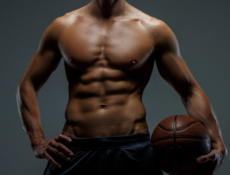Muscular female with basket ball.