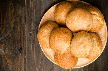 Homemade buns on wooden plate