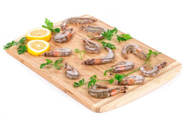 Fresh shrimps on wooden board.