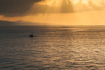 A lone fisherman in a boat. Adriatic Sea before the storm