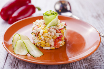 salad from crabsticks, a cucumber and corn