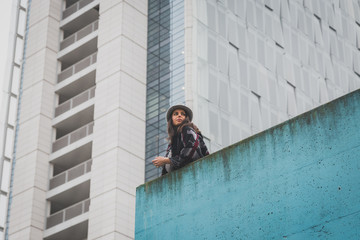 Beautiful young brunette posing in the city streets