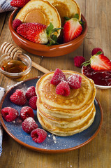 Small pancakes with berries and syrup.