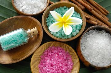 colorful sea salt ,flower in wooden bowl with cinnamon on banana leaf 