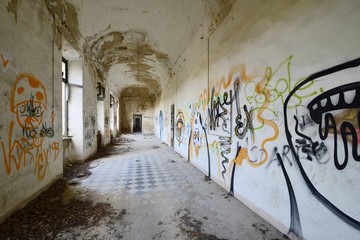 old abandoned corridor with graffiti.