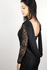 Fototapeta premium beautiful brunette with an open dress in the back