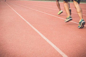 Fototapeta premium Running track with blur of runner feet in stadium