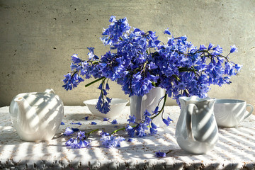 Still life bouquet blue tones white crockery