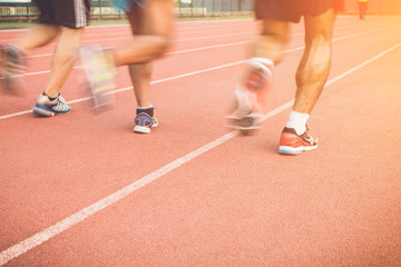Running track with blur of runner feet in stadium