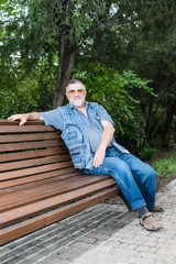 Fototapeta premium grandfather in the park relaxing on the grass