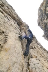 A hiker on the via ferrata of Chianocco ( Italy )