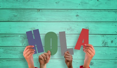 Composite image of hands holding up hola - Powered by Adobe