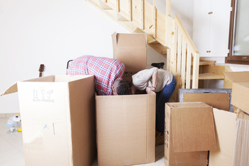 young couple opened the boxes for the new house