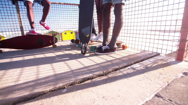 Close-up of longboarder feet and their skateboards
