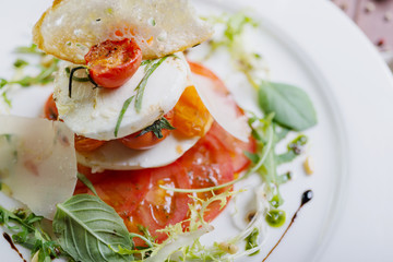 Plate of healthy classic caprese salad with mozzarella cheese