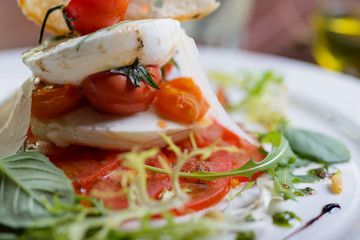 Plate of healthy classic caprese salad with mozzarella cheese