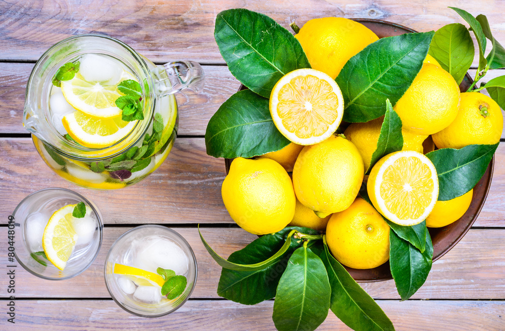 Wall mural Water with lemon and mint in glasses and jug.Healthy drink,detox