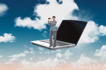 Composite image of businesswoman posing with binoculars