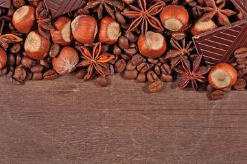 Coffee, chocolate, star anise and hazelnuts on a  wooden