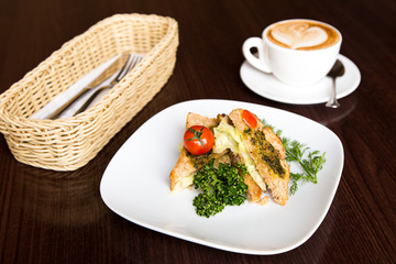 breakfast sandwich with a cup of coffee on the table