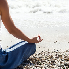 Young woman meditation on the beach