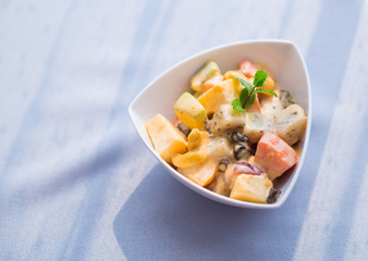 White bowl of fresh healthy fruit salad