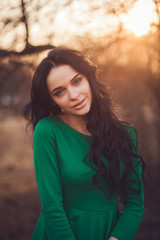 Fototapeta premium portrait of a cute girl in the spring park. sunset