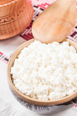 curd in brown bowl on the Ukrainian rushnyk