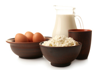 Cottage cheese and eggs in pottery and glass jug of milk