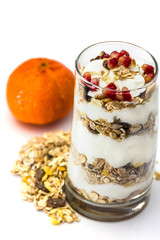 Glass of Muesli with fruits and yogurt isolated on white