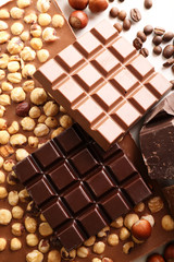Chocolate bars with hazelnuts and coffee beans close up