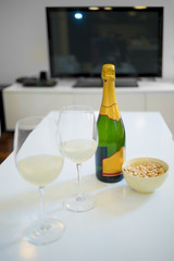 Bottle and glass of champagne in a living room