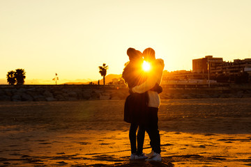 Couple is kissing at the sunset on the beach - 80455415