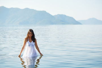 Fototapeta na wymiar Beautiful woman in a tranquil sea