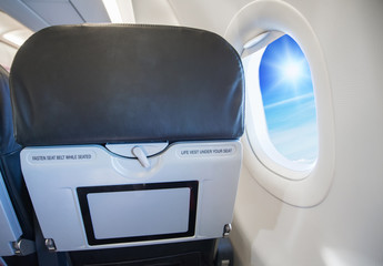image of fasten seat belt while seated sign on airplane.