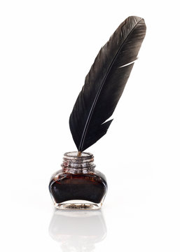 Inkwell with quill pen isolated on completely white background.