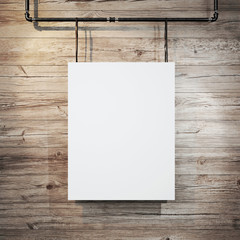 White poster hanging on leather belt on wood background