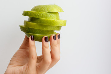 Hand holding green apple