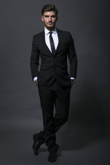 Handsome businessman adjusting his tie