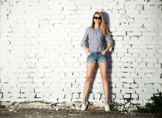 Trendy Hipster Girl at the Brick Wall