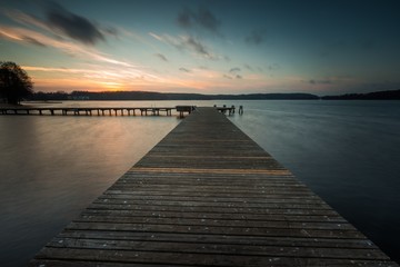 Fototapeta na wymiar Lake landscape with jetty. Long time exposure