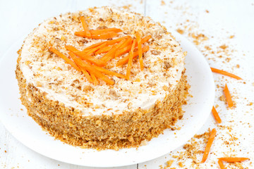 Fresh backed carrot sponge cake with walnut crumbs and carrots