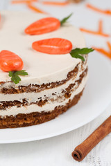 Homemade carrot cake pasrty with icing on white plate