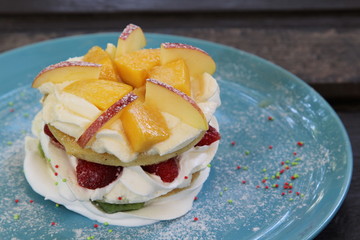 Mixed fruit pancakes on blue plate.