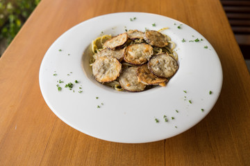 Spaghetti with a slice of grilled eggplant served