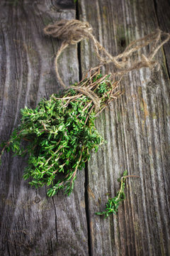 thyme bunch on an old wooden background