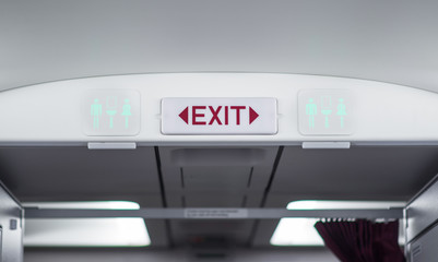 Exit and toilet sign on plane