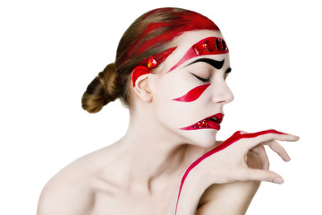 Studio portrait of a woman. Art make-up in red.
